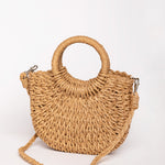 Bolso de rafia camel con bandolera desmontable trenzada y asas redondas.