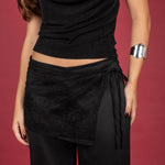 pañuelo tipo pareo de encaje negro, un accesorio versátil que eleva cualquier look. Diseñado para usarse atado a la cintura, este pañuelo combina delicadeza y sofisticación gracias a su textura semitransparente y detalles en encaje floral.