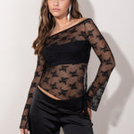 Top de encaje negro manga larga transparente con corte off shoulder y diseño floral. Ideal para tus looks de estas navidades.